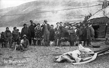Preobrazhenie Bay: Chukchi in front of their home, in national traditional fur clothing..., 1910-29. Creator: Ivan Emelianovich Larin.