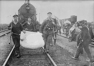Germans helping refugees returning to Antwerp, 1914. Creator: Bain News Service.