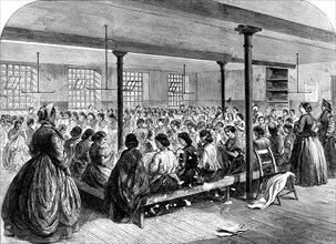 The Cotton Famine: the sewing-class at the Manchester...Provident Society's rooms, 1862. Creator: Unknown.