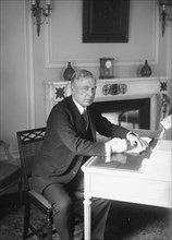 F. Lowden, seated at desk, writing, 1919. Creator: Bain News Service.