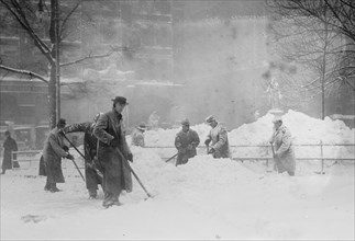 Shovelling snow in City Hall Park, New York, 1910. Creator: Bain News Service.