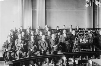 Candidates for naturalization seated in room, hats in laps, 1916. Creator: Bain News Service.