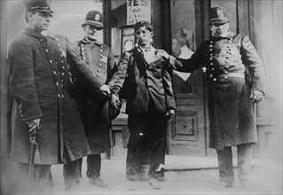 Battered striker with policemen, Philadelphia, 1910. Creator: Bain News Service.
