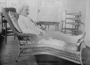 S.L. Clemens reclining in porch chair, 1910. Creator: Bain News Service.