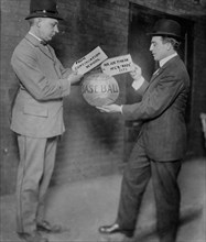 Joe Tinker receiving medicine ball sent by Continuation School 1913, 1913. Creator: Bain News Service.