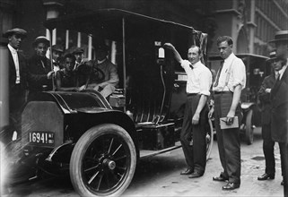 Inspector Walsh condemning taxicab, 1913. Creator: Bain News Service.