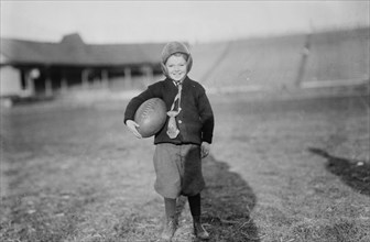 Hughey Gold [child with football], between c1910 and c1915. Creator: Bain News Service.