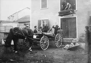 Rimouski - handling coffins of victims, 1914. Creator: Bain News Service.