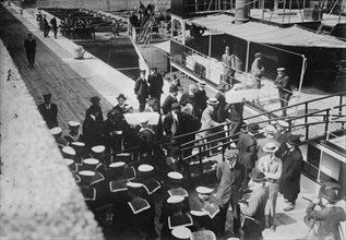 Sailors taking children in coffins from LADY GREY at Quebec, 1914. Creator: Bain News Service.