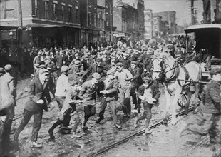 Rioters charging horse-drawn car, later wrecking it on Kensington Ave., Philadelphia, 1910. Creator: Bain News Service.