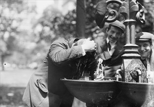 Cooling his head - N.Y. on hot day, between c1910 and c1915. Creator: Bain News Service.