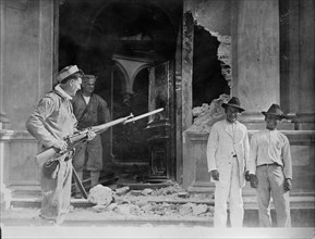 Vera Cruz: Front door of Naval Academy bombarded by "CHESTER" & "PRAIRIE", 1914. Creator: Bain News Service.
