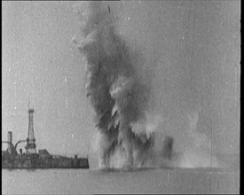 Bombs Dropped from Planes Exploding near a Warship, 1922. Creator: British Pathe Ltd.