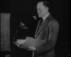 A Man Reading from a Book for the British Broadcasting Corporation, 1922. Creator: British Pathe Ltd.