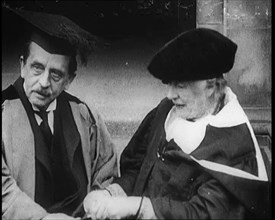 Sir James Barrie and Ellen Terry Sitting Together in Academic Dress Outside St Andrew's Uni, 1922. Creator: British Pathe Ltd.