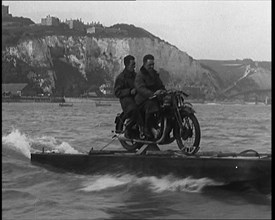 Two Male Civilians Riding a Motorcycle on a Float Across the English Channel, 1929. Creator: British Pathe Ltd.