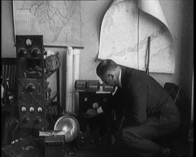 Male Detective Showing off Smugglers' Radio Equipment, 1929. Creator: British Pathe Ltd.