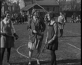 A Female Civilian Tossing a Coin in Front of Two Young Female Lacrosse Players Ahead of the..., 1920 Creator: British Pathe Ltd.