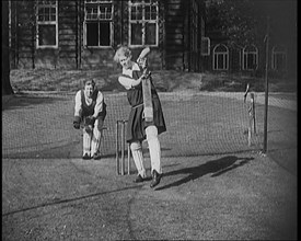 Two Female Civilians Wearing Gymslips and Batting Pads Preparing to Bat in a Playing Field, 1920. Creator: British Pathe Ltd.
