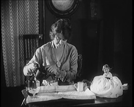 Female Civilian Seating at a Table Serving Tea, 1920. Creator: British Pathe Ltd.