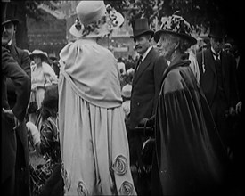 Civilians on the Street Wearing Evening Outfits, Hats and Top Hats, 1920. Creator: British Pathe Ltd.