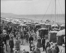 Civilians Enjoying a Sunny day on a Very Crowded Beach, 1920. Creator: British Pathe Ltd.