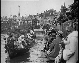 Civilians on the Margin of a River Throwing Flowers to  Civilians on a Boat Heavily Decorated...1920 Creator: British Pathe Ltd.