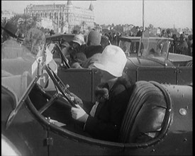 Female Civilian Wearing a Fur Trimmed Coat and Hat Sitting Behind the Wheel of a Car, 1920. Creator: British Pathe Ltd.