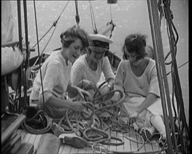 Female Civilians Wearing Summer Outfits and a Captain's Hat Onboard of a Boat Untangling a Rope,1920 Creator: British Pathe Ltd.