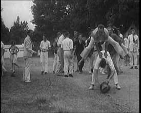 A Male Civilian Leapfrogging over Another Male Civilian Outdoors in a Holiday Camp, 1920. Creator: British Pathe Ltd.