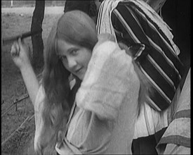 Female Civilian Brushing Her Long Hair Outdoors, 1920. Creator: British Pathe Ltd.