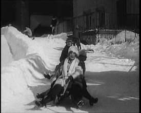 A Group of Civilians Having Fun Sledging down a Snowy Hill, 1920. Creator: British Pathe Ltd.