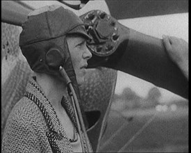 American Aviator Amelia Mary Earhart Wearing a Helmet in Front of an Airplane, 1920. Creator: British Pathe Ltd.