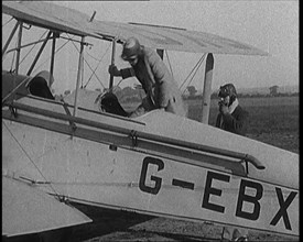 American Aviator Amelia Mary Earhart Wearing a Helmet Boarding an Airplane, 1920. Creator: British Pathe Ltd.