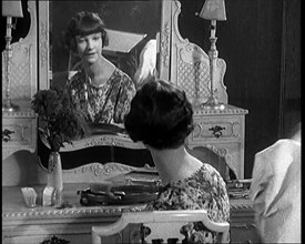 Female Civilian Admiring Herself in a Mirror After Having Her Hair Cut Into a 'Shingle', 1920. Creator: British Pathe Ltd.