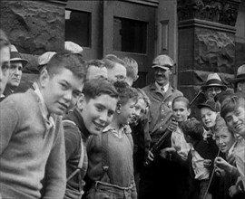 A Group of American Children Civilians Gathering Outside an Official Building with a Male..., 1930. Creator: British Pathe Ltd.