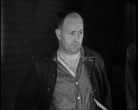 A group of Male Americans Civilians Wearing Prisoners Outfits Being Escorted Into a Room..., 1930. Creator: British Pathe Ltd.