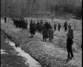 American Police Officers Searching the Area Outside American Aviator Charles Augustus..., 1930s. Creator: British Pathe Ltd.