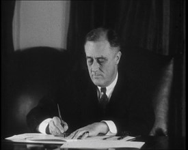 President Franklin D Roosevelt Signing Papers Behind a Desk, 1930s. Creator: British Pathe Ltd.