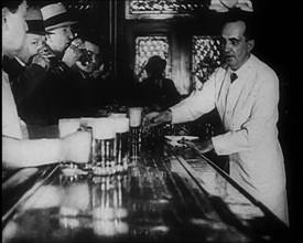 American Civilians Celebrating the End of Prohibition Drinking in a Bar, 1930s. Creator: British Pathe Ltd.