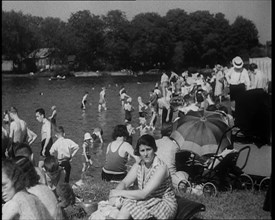 Large Group of People Sitting Outside and Paddling, 1933. Creator: British Pathe Ltd.