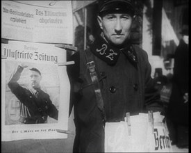 Man Standing by a Poster of Adolf Hitler, 1933. Creator: British Pathe Ltd.