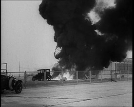 Plume of Flame Burning with Cars Nearby, 1933. Creator: British Pathe Ltd.