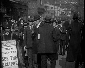 Men Wearing 'Pathe Gazette' Sandwich Boards Handing Out Pieces of Polaroid Film to Crowds..., 1921. Creator: British Pathe Ltd.