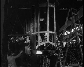 Men and Women Building the Body of the Cockpit of an R 38 Airship in a Hangar, 1921. Creator: British Pathe Ltd.