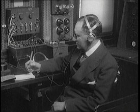 Italian Senator Guglielmo Marconi Using Radio Apparatus While Taking Notes, 1920. Creator: British Pathe Ltd.