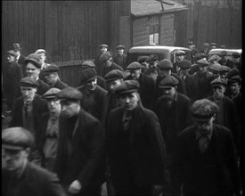 Crowd of Men Walking Through the Street Towards the Camera, 1933. Creator: British Pathe Ltd.