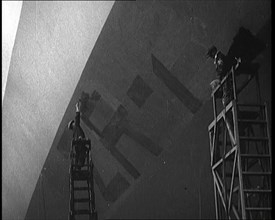 An R 38 Airship Body Being Painted in a Hangar, 1921. Creator: British Pathe Ltd.