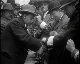 A Group of Male Civilians Volunteers Being Issued With White Arm Bands, 1926. Creator: British Pathe Ltd.