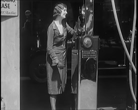 Female Civilians Working Petrol Pumps in a Garage, 1931. Creator: British Pathe Ltd.